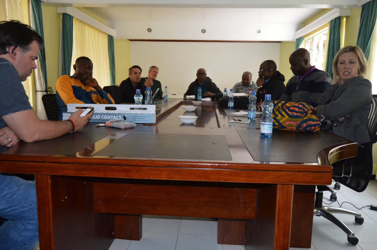 Founders sit around a large conference table at Thayu resort, engaged in a strategy session with water bottles and notebooks, during the September 2016 SPEC founding retreat.
